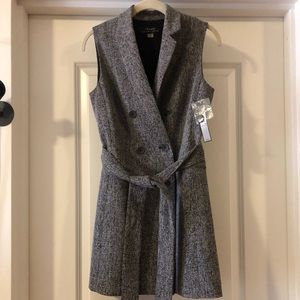 Sleeveless long vest/jacket.  Tie belt.